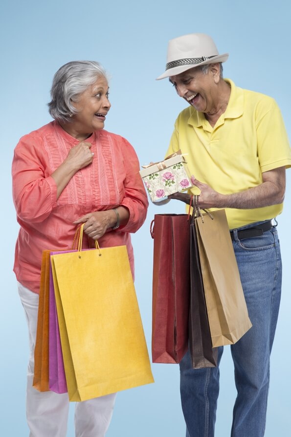 old couple with shopping bags 