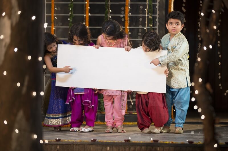 cheerful small group of kids holding a message board