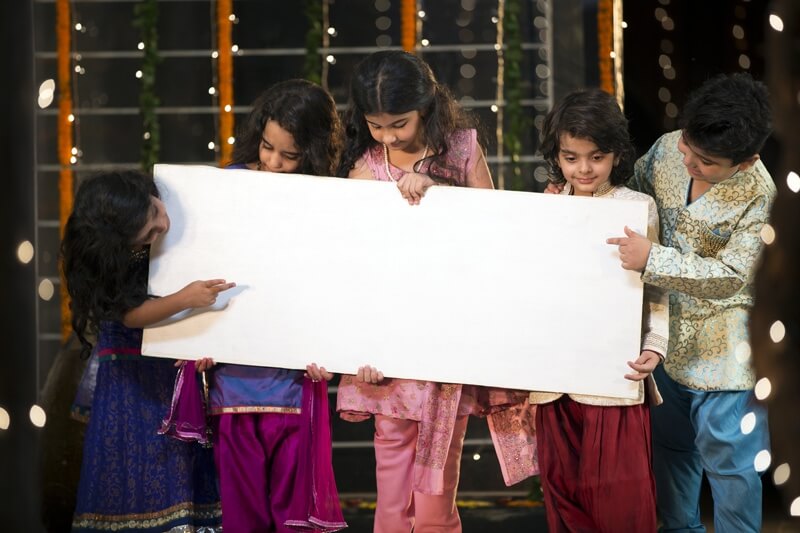 cheerful small group of kids holding a message board