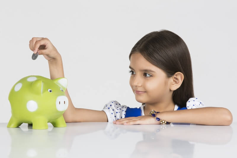 young girl with her piggy bank 