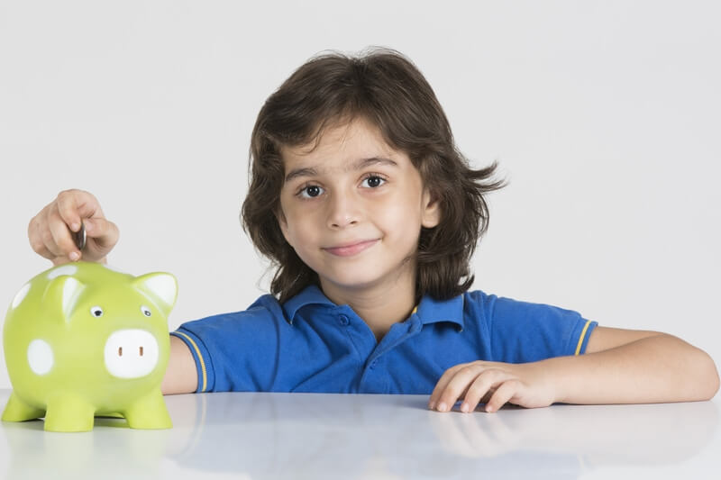 young boy with his piggy bank 
