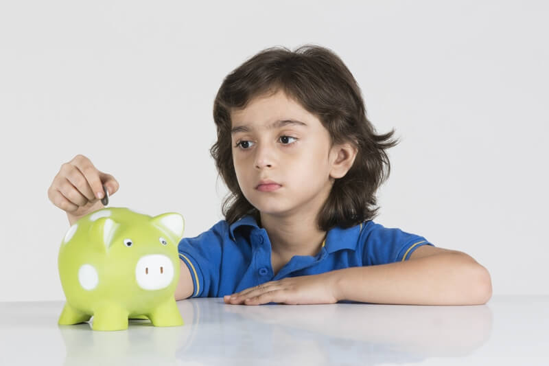 young boy with his piggy bank 