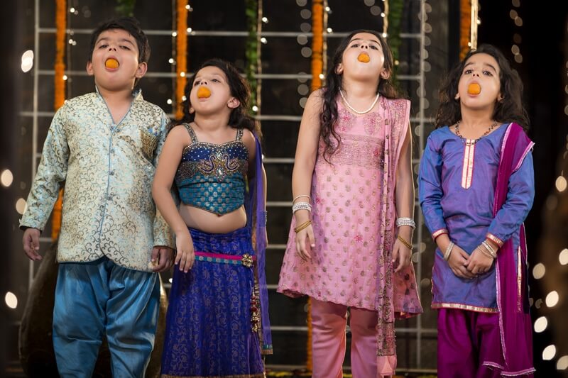 kids eating ladoo on diwali 