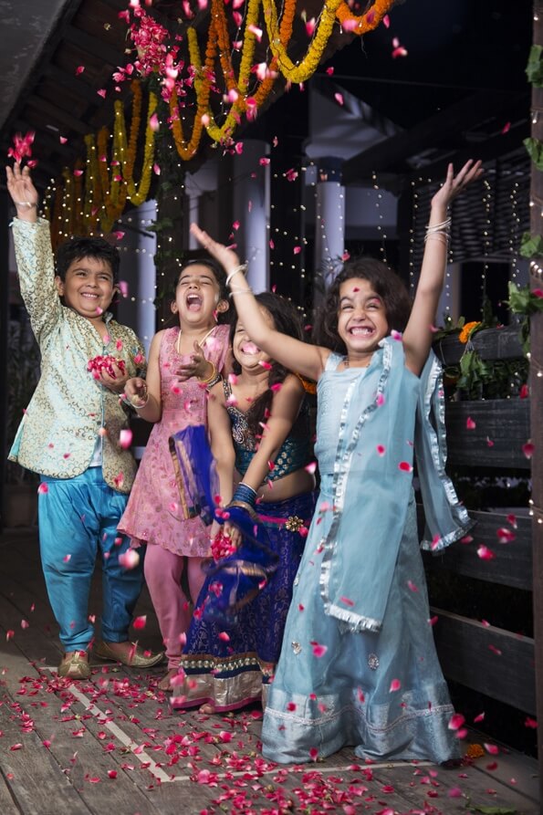 kids playing with rose petals on diwali 