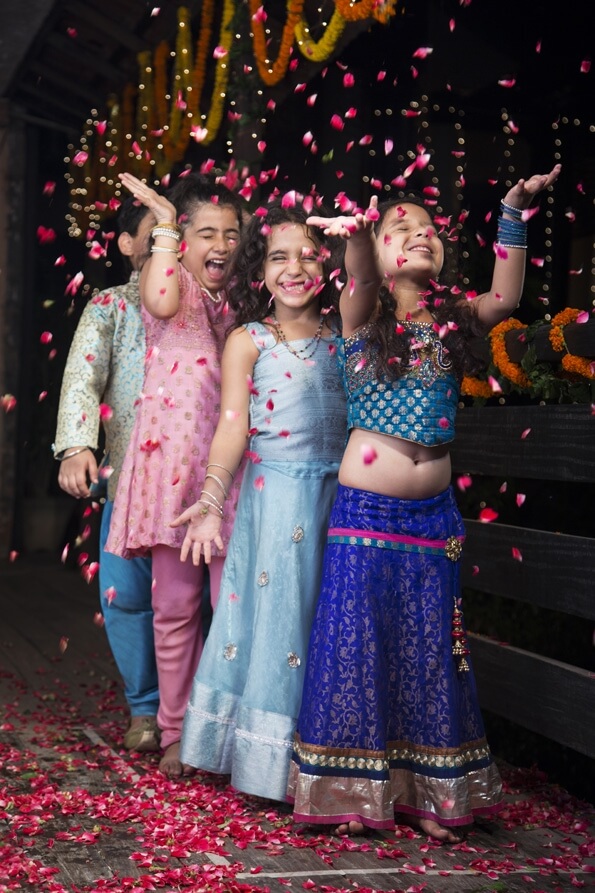 kids playing with rose petals on diwali 