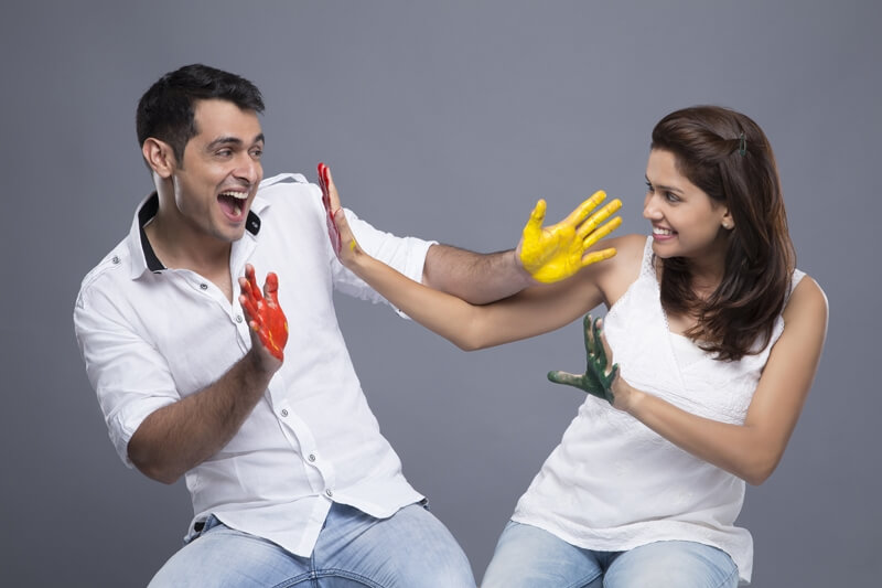 couple applying colours to each other 
