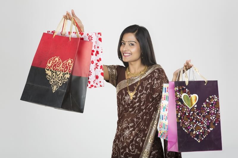 woman in saree with shopping bags 