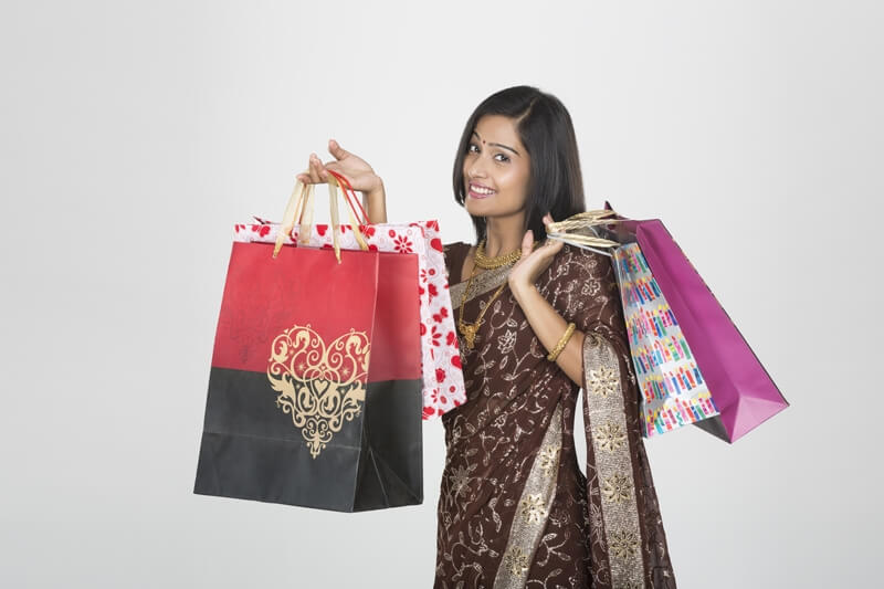 woman in saree with shopping bags 
