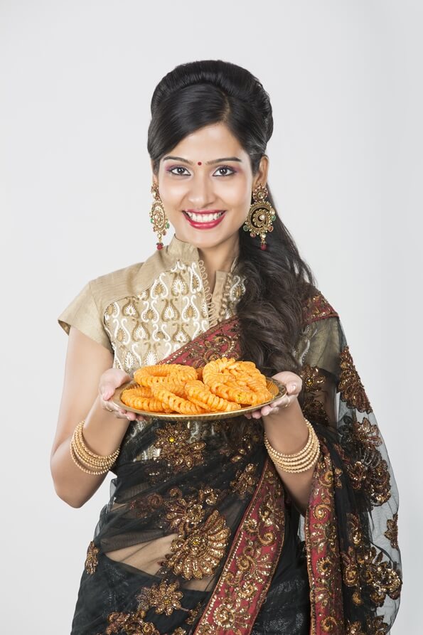 woman in saree with sweets 