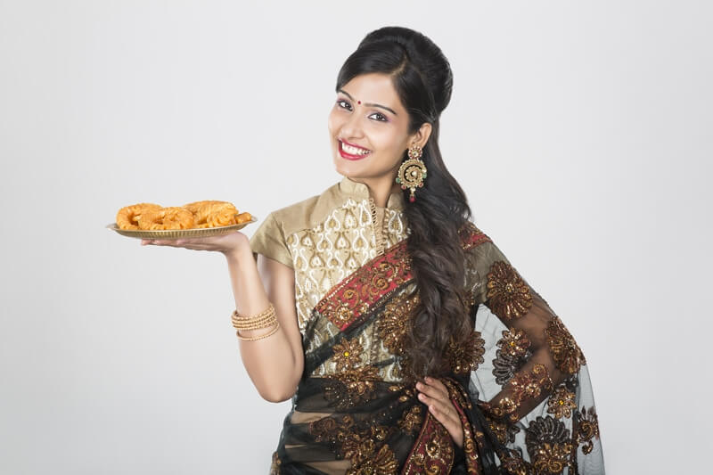 woman in saree with sweets 