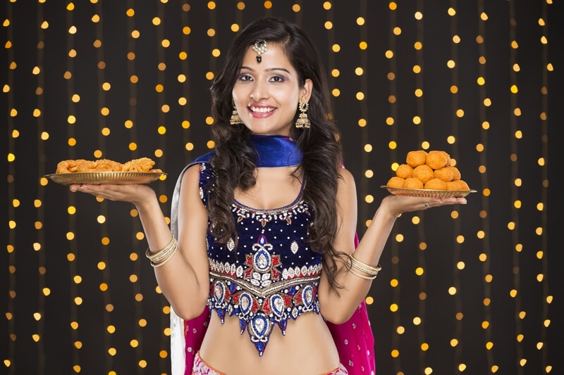 woman in ethnic wear with sweets 