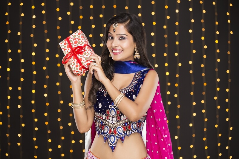 woman in traditional wear with a gift 