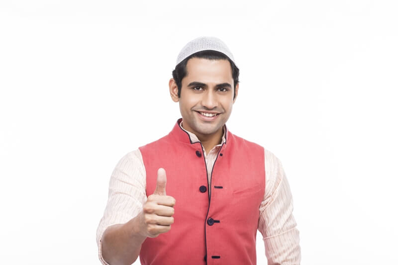 muslim man wearing a cap and doing thumbs up