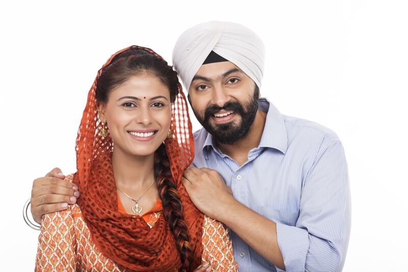 sikh couple smiling and posing 