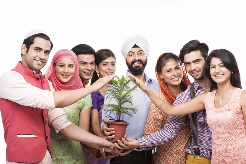 people from all religions posing with a plant 