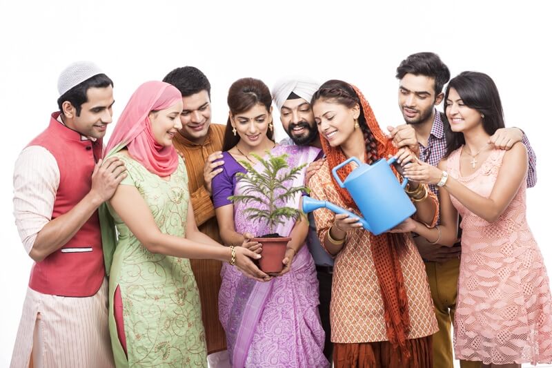 people from all religions giving water to a plant