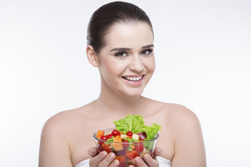 girl smiling and posing with salad