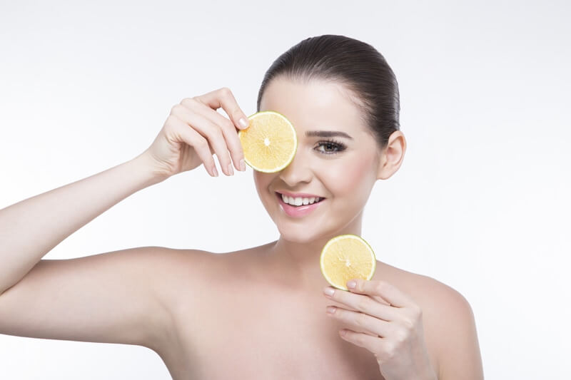 girl posing with lemon slices 