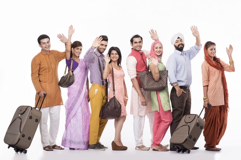 group of people posing with travel bags 