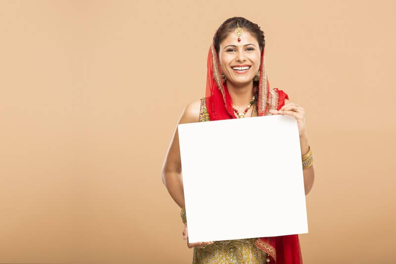 woman posing with message board and smiling