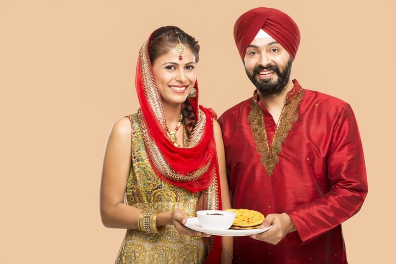 sikh couple with their traditional food 