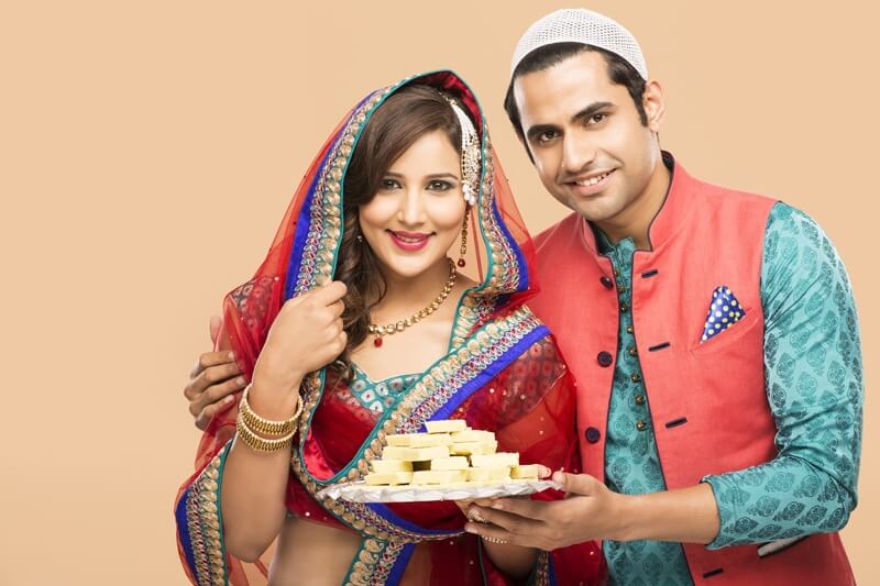 muslim couple posing with sweets