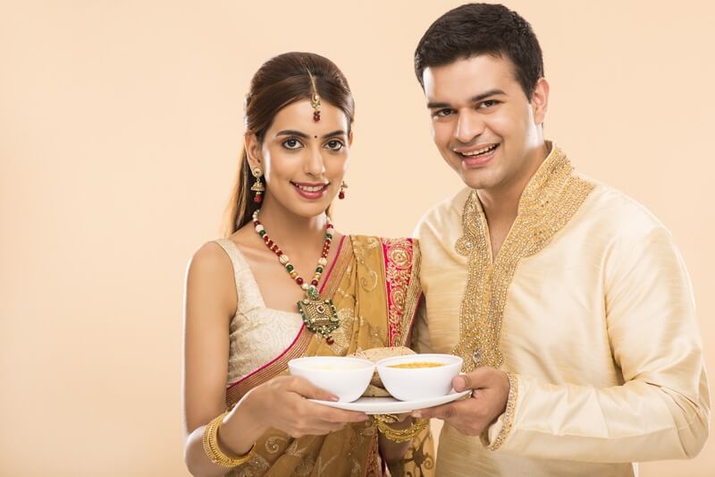 hindu couple with a plate full of food 