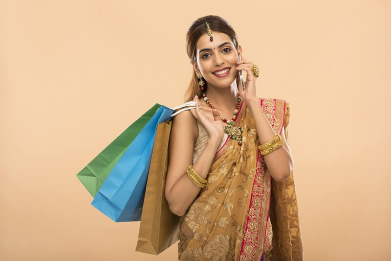 woman with shopping bags and mobile phone