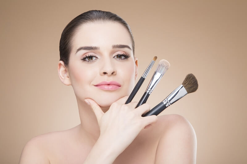 girl posing with make up brush