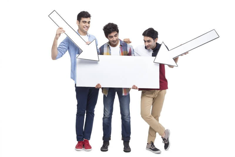 three friends posing with placard