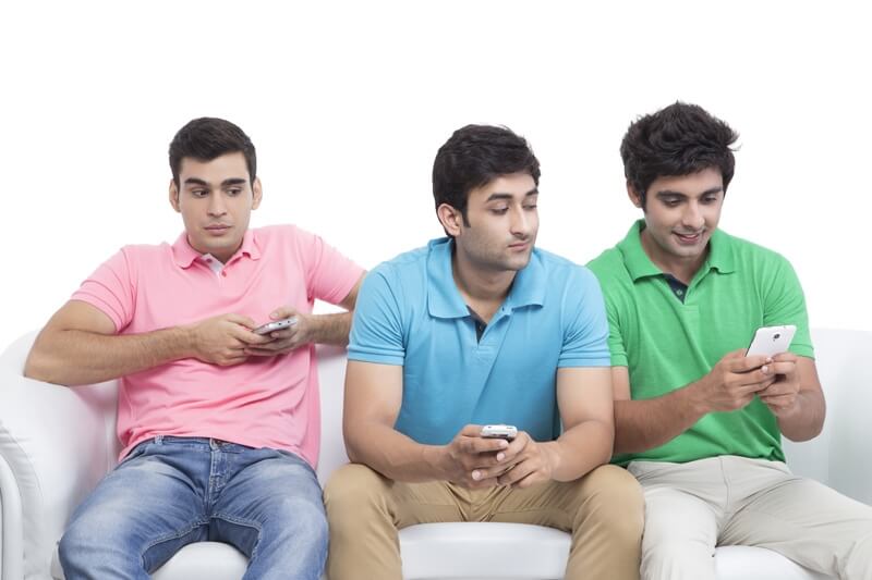 three friends messaging on mobile phone