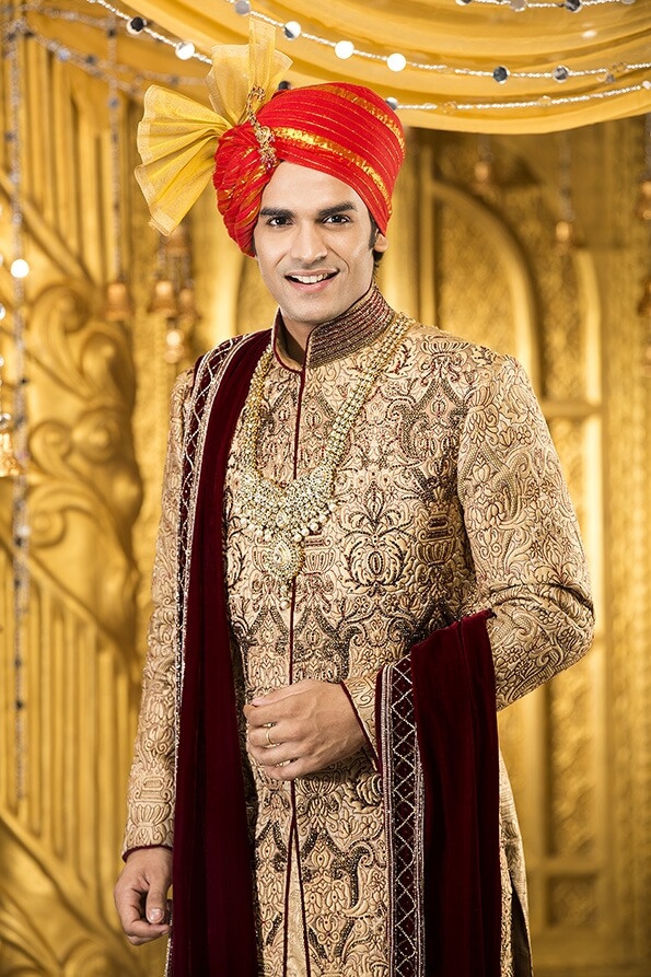 indian groom smiling and posing 
