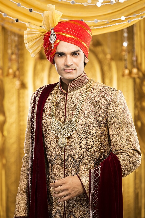 indian groom smiling and posing 