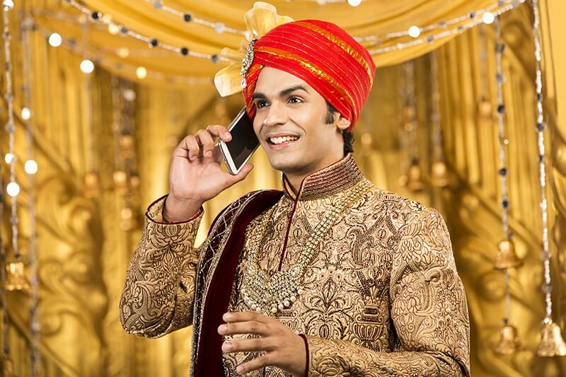 indian groom talking on phone 