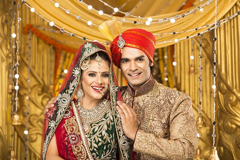indian bride and groom posing 
