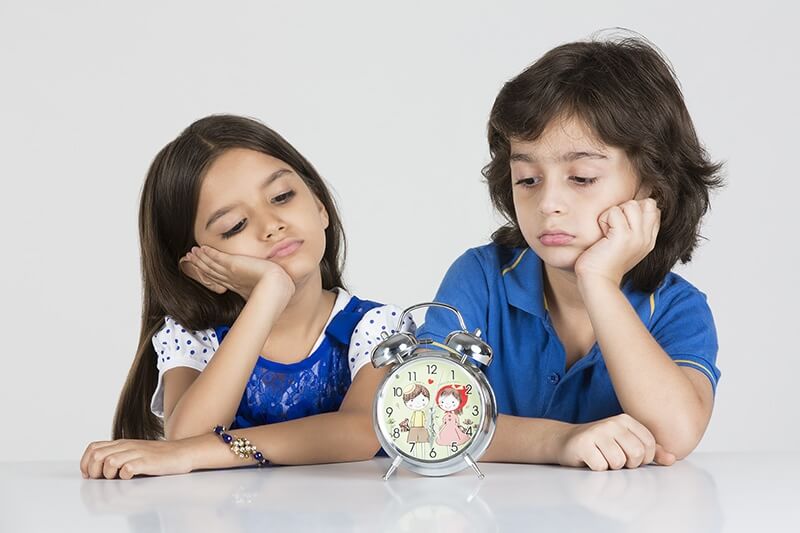 young kids with a table clock 