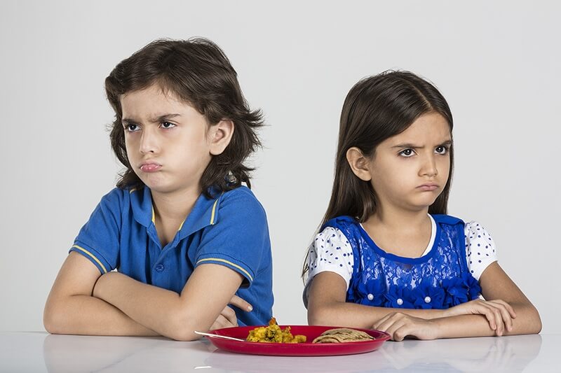 two kids unhappy with home made food
