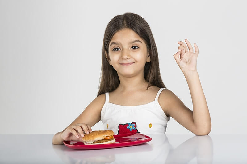 cute little girl posing with delicious burger