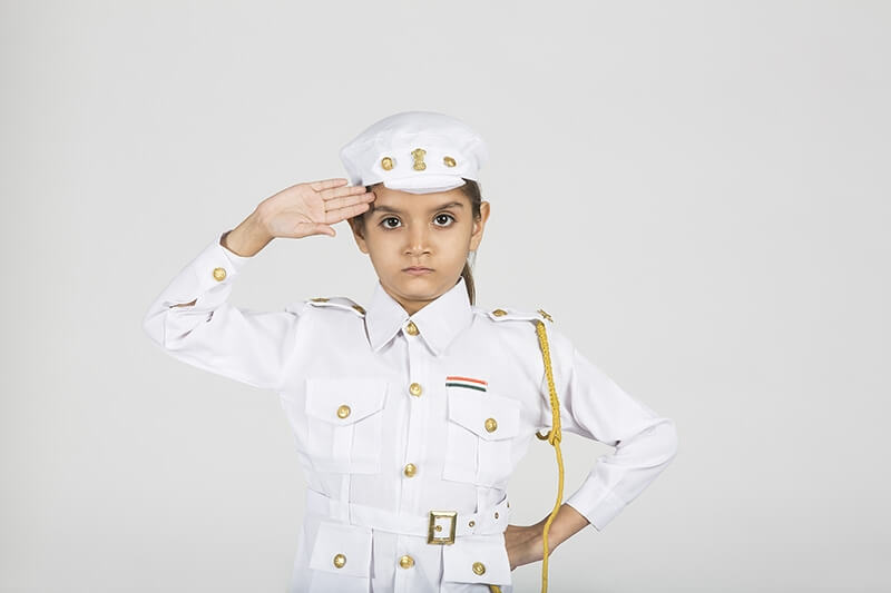 child in traffic police attire saluting and posing