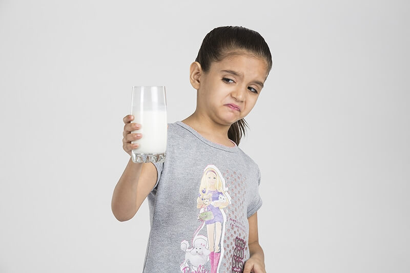 child with a glass of milk