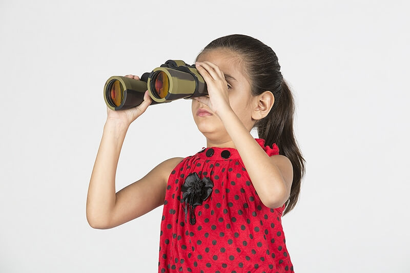 child looking through binoculars 