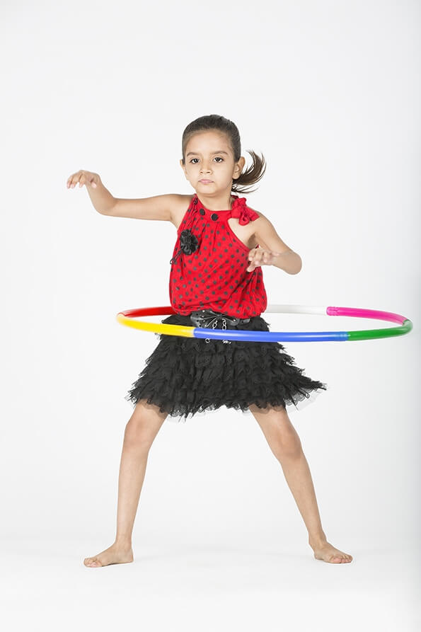 cute child performs with hula hoop