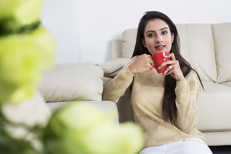 woman sitting at home with coffee mug