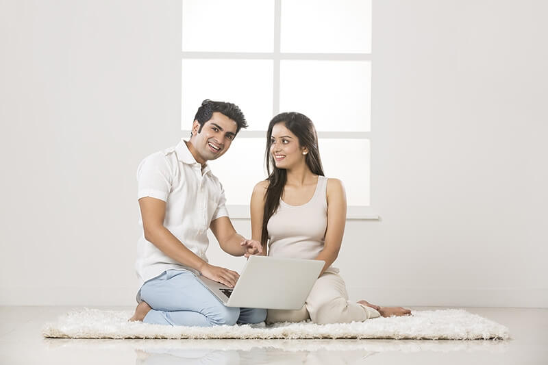 couple at home working on laptop