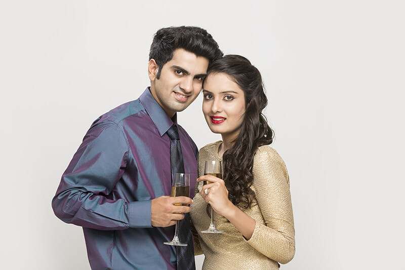 couple posing with champagne glasses 