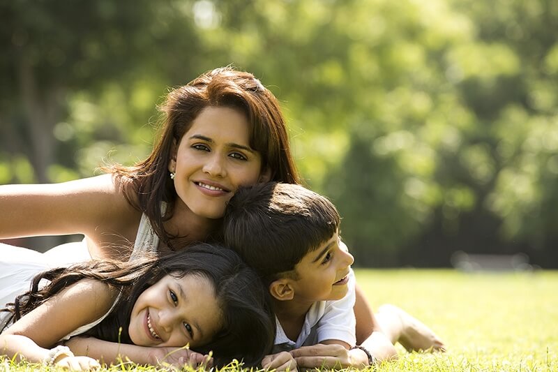 mother enjoying weekend with children at park
