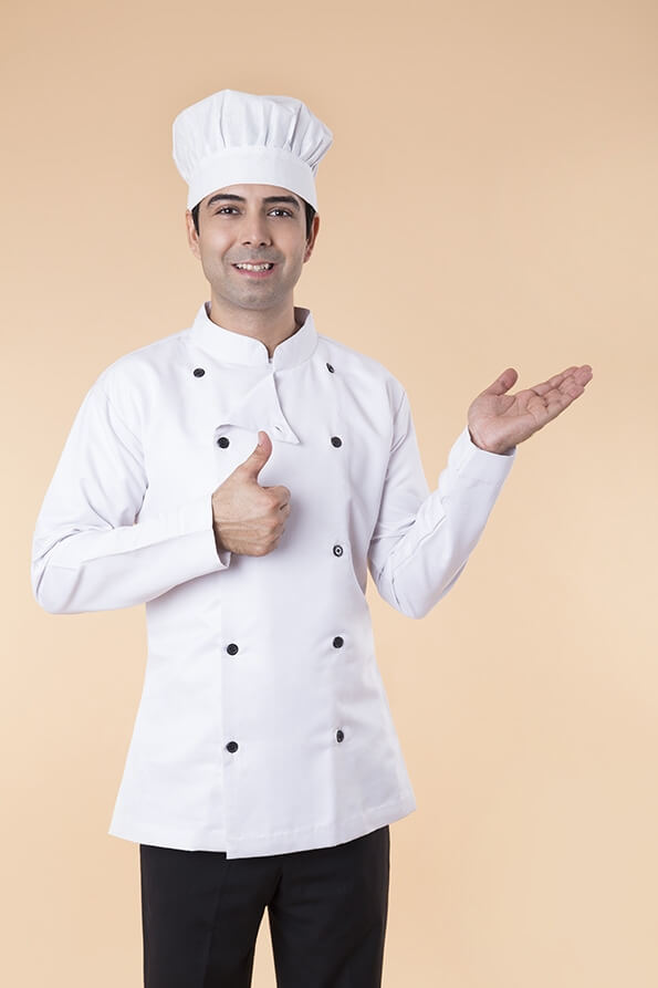 chef wearing chef cap pointing towards something