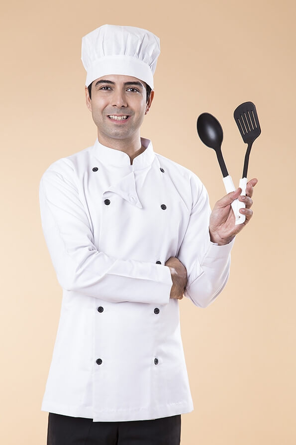 chef posing with spatula and ladle