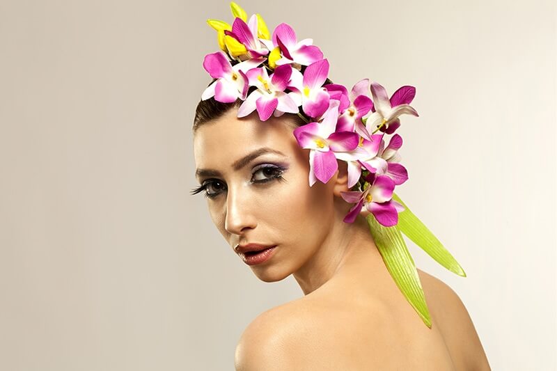 beautiful young woman posing with flowers in hair