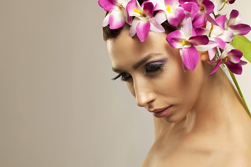 beautiful young woman posing with flowers in hair